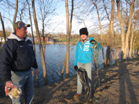 Boy Scouts of Melrose Troop 68 clean trash along river shoreline.